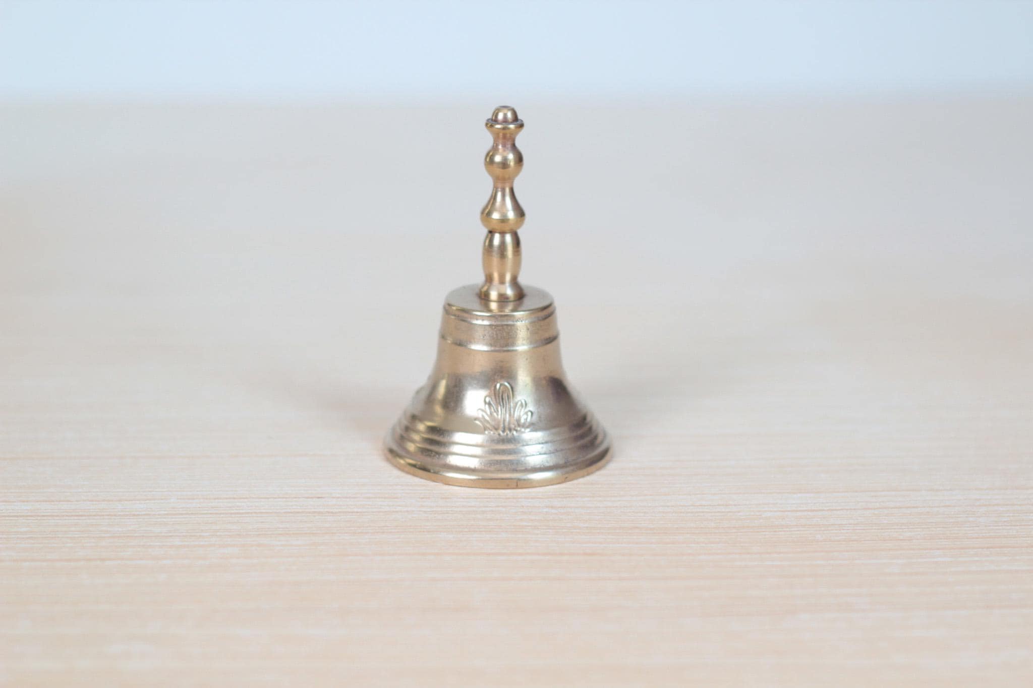 Vintage Midcentury Brass Hand Bell with Raised Floral Motif